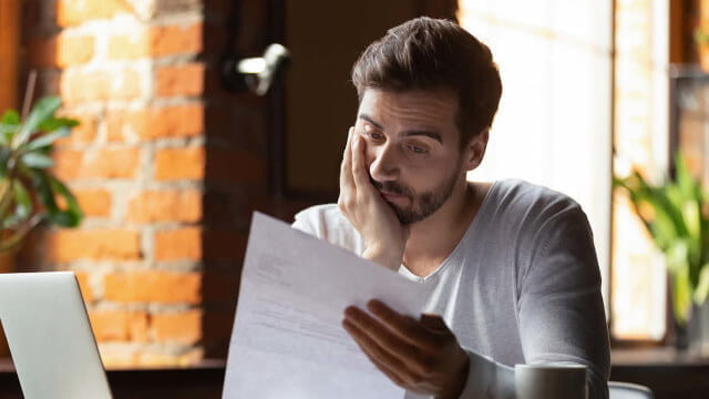 Tired person looking at paperwork