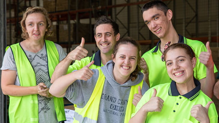 Group of smiling workers in high visibility workwear