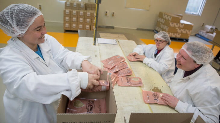 Endeavour Foundation staff working in a factory to package food