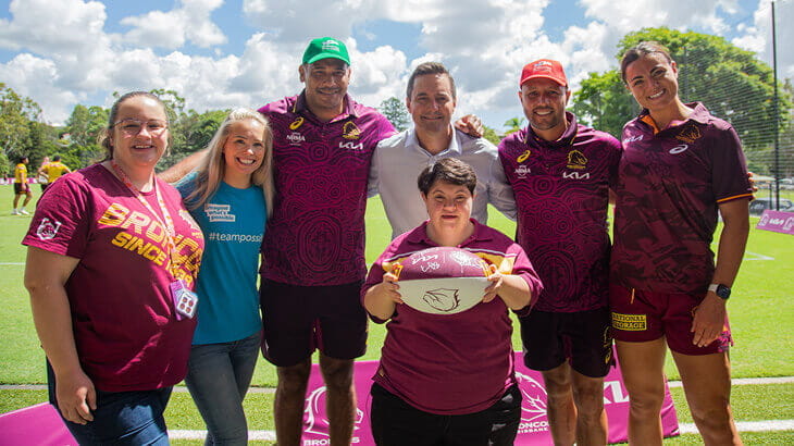 Members of Brisbane Broncos and Endeavour Foundation clients and staff in a group setting