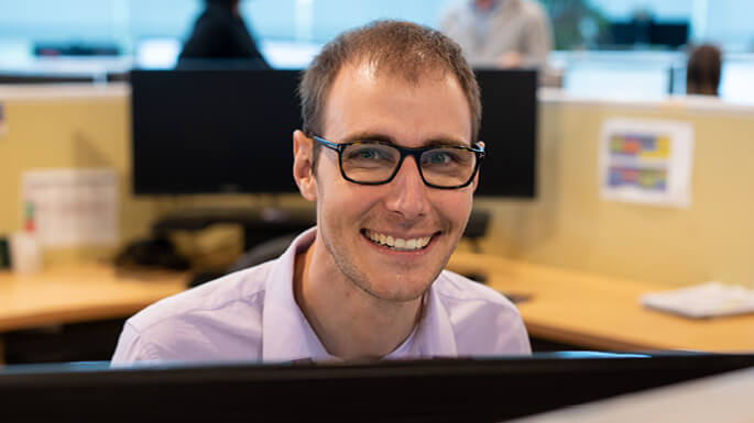 Man-in-office-smilingjpeg