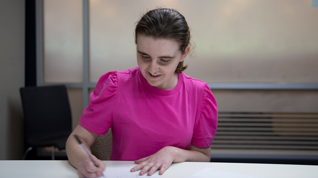person-writing-on-document-at-table.jpg
