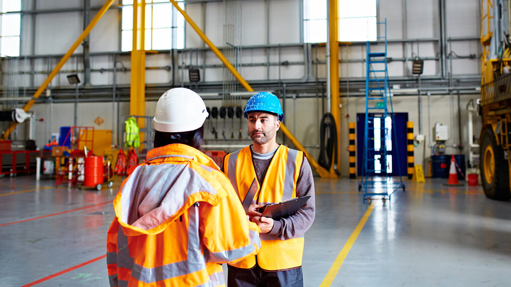 two-people-wearing-safety-gear-in-warehouse.jpg