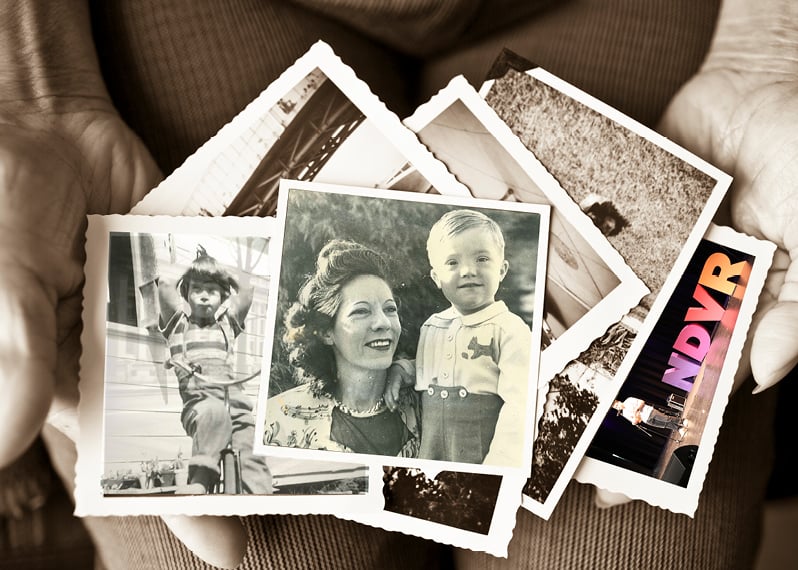 person-holding-old-photos-in-their-hands