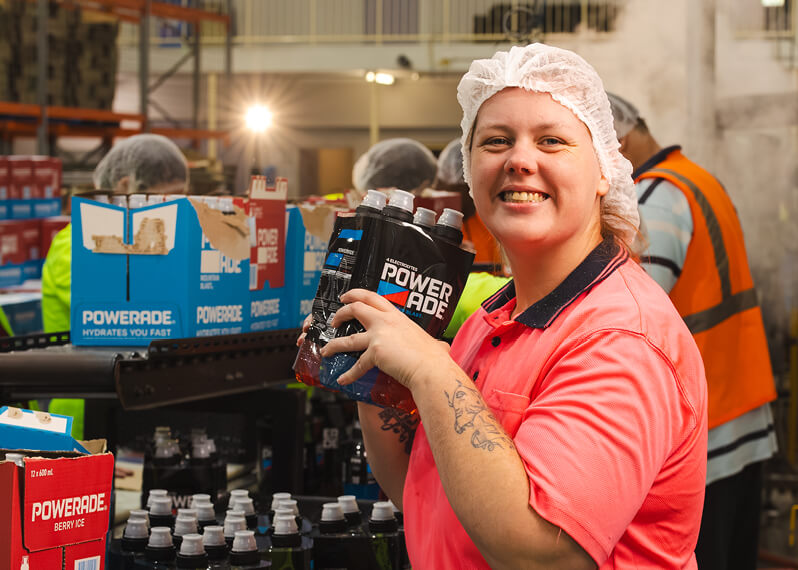 employee-smiling-while-on-production-line.jpg