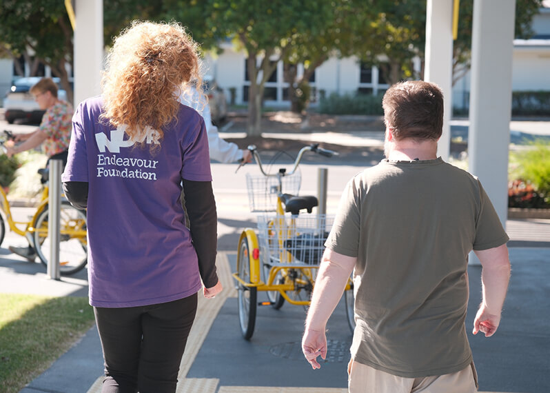 participant-and-support-worker-walking-outdoors.jpg