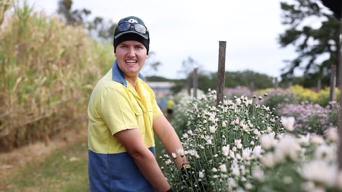Man-smiling-in-flower-fieldjpeg