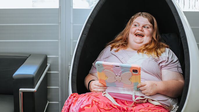 Woman-sitting-and-smilingjpeg