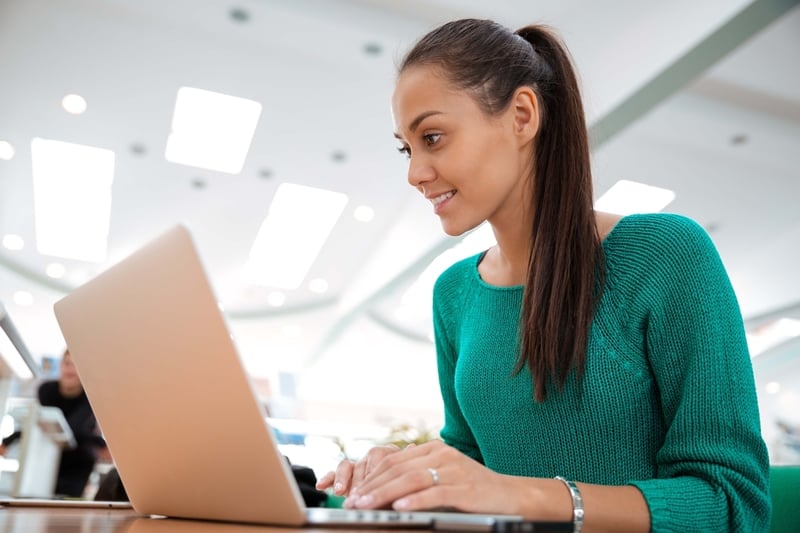 Female student using laptop computer in university
