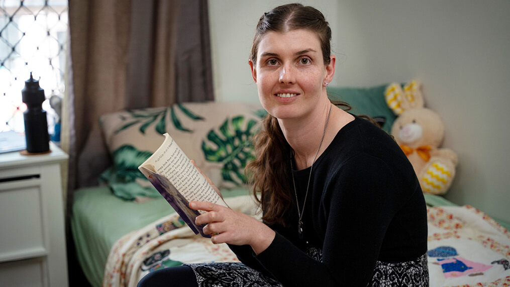 participant-reading-book-in-bedroom.jpg