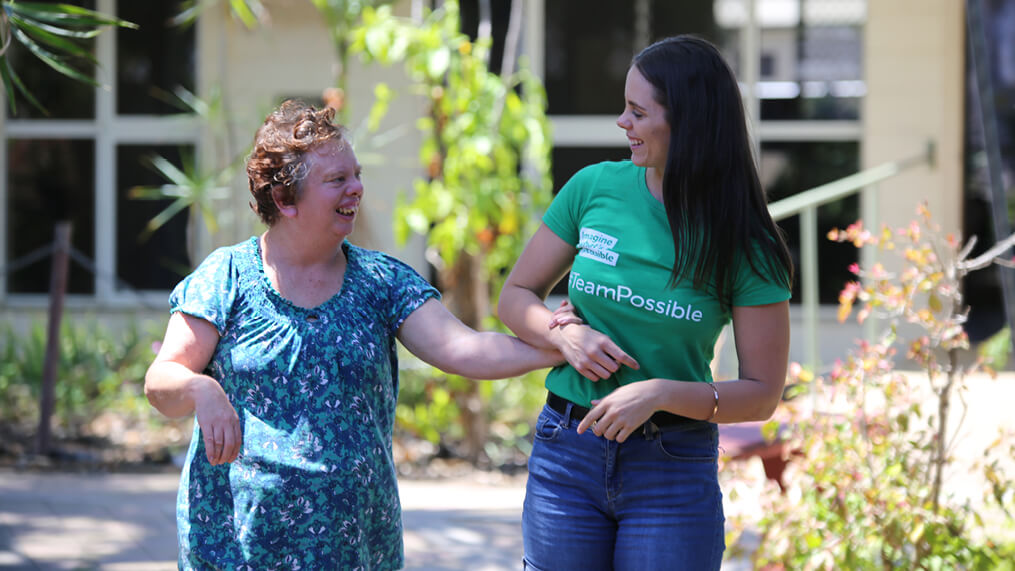 participant-and-support-worker-walking-together-outdoors.jpg