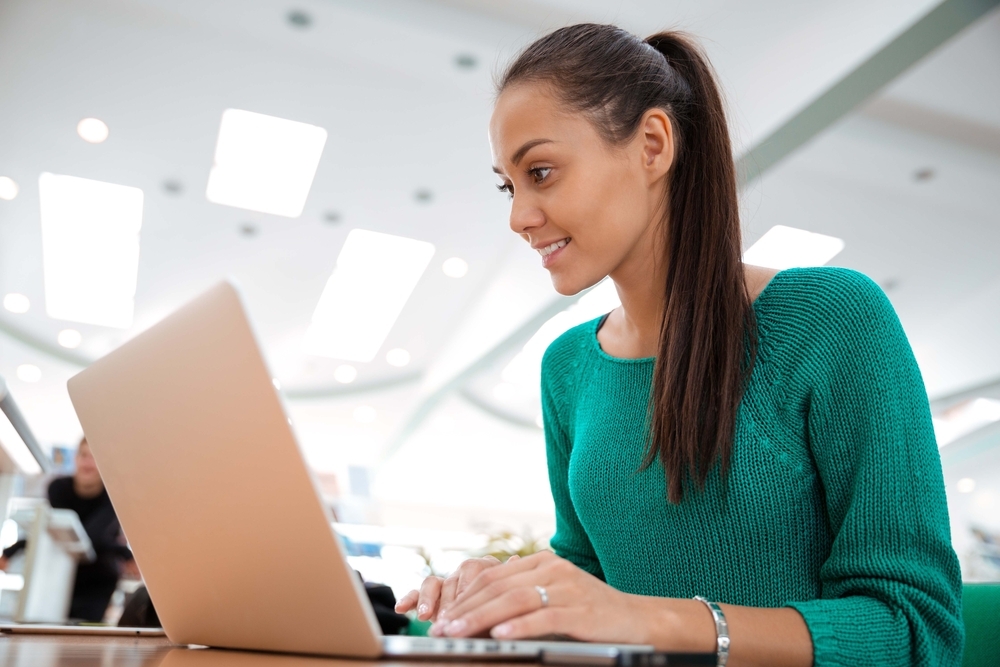 Female student using laptop computer in university